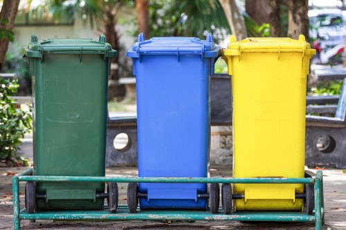 Workers sorting recyclables from a skip at a transfer station