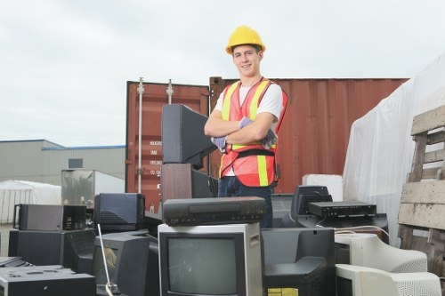 Workers assessing a skip loading area with safety gear on